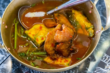 Thai sour curry soup with vegetable omelet and fried fish.