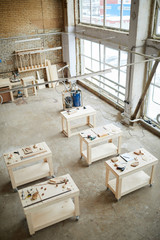 Wide angle background of workstations table in industrial woodworking shop, copy space