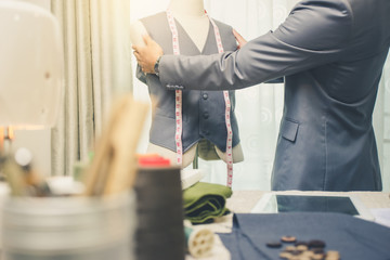 Obraz premium Fashion designer fitting bespoke suit to model,