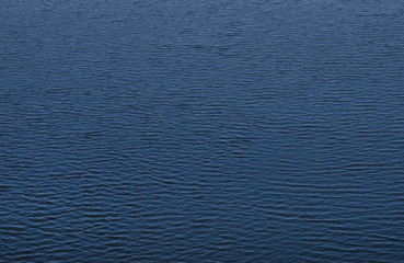 Fototapeta na wymiar water surface with small ripples, top view