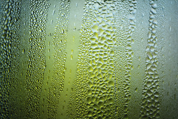 Transparent glass steamed with steam, condensation of water and small drops of hot water over the entire surface with interesting light illumination and polish.