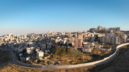 Israel Palestine divided by security fence in Jerusalem aerial view Drone flight view of east...