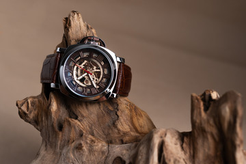 Close up of Luxury man wrist watches placed on timber in brown background or isolated