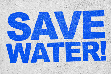 The inscription "Save water!" on concrete wall