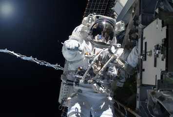 Astronaut in outer space near the space station.Elements of this image were furnished by NASA