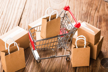 shopping online at home concept.Cartons in a shopping cart on a laptop keyboard.online shopping is a form of electronic commerce that allows consumers to directly buy goods from a seller over internet