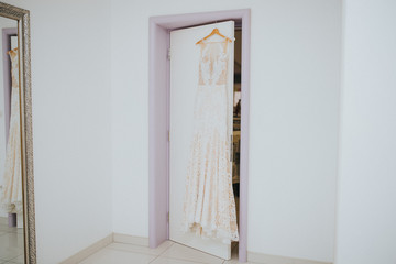 wedding dress hanging on doors