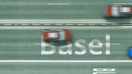 Aerial down view of the motorway with cars revealing Basel caption. Car travel to Switzerland intro clip