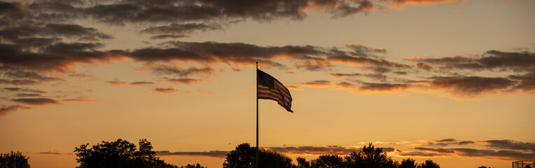 American flag in a vibrant sunset panorama