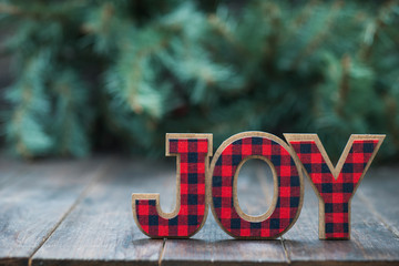 The Word JOY with a tree and wood background