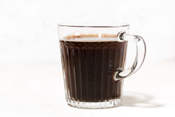 glass mug of freshly brewed black coffee