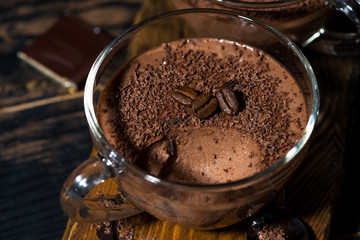 sweet chocolate mousse in glass cup, closeup