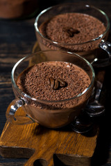 sweet chocolate mousse in glass cups, vertical