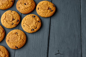 Chocolate cookies on a dark wooden table. Top view.