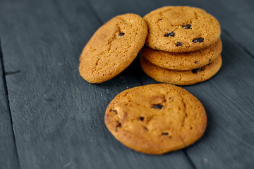 Chocolate cookies on a dark wooden table.