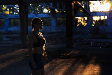 Fitness girl outdoors with low sunlight and shadows