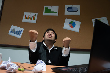 Asian businessman under stress due to excessive work,Feeling exhausted,Young clerk has a problem in a office,sad man from work,Angry messy man concept