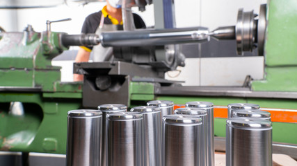  factory employee engaged in the production of pin bushing on the lathe in the factory