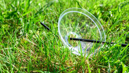 Environmental pollution: plastic cap lies in the grass.