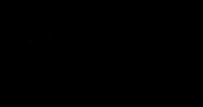 Fire artist man breathing burning flame in the dark