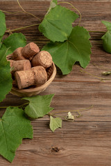 background with grape leaves and wine bottle corks on wood
