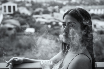 Fototapeta na wymiar Sexy woman smoking on balcony