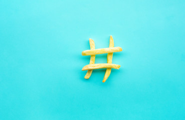 Hashtag sign icon with french fried on blue color background.Food, nutrition and social...