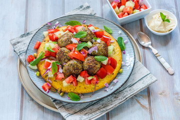  Curried chickpea cake with pistachio lamb meatballs and tomato sambal