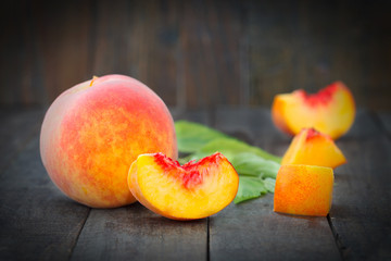 Fototapeta na wymiar Fresh sweet peaches on the wooden table. Healthy summer fruit.