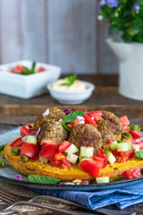 Curried chickpea cake with pistachio lamb meatballs and tomato sambal
