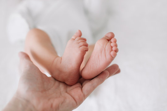 Newborn baby feet. Tiny baby feet closeup. Happy Family concept. 