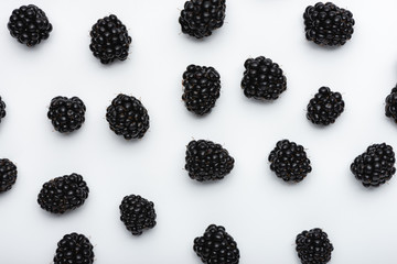 Closeup of fresh organic blackberries on a white background, top view