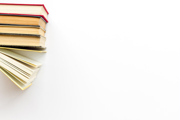 Books on library desk on white background top view space for text