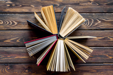 Naklejka premium Books on library desk for reading and education on wooden background top view