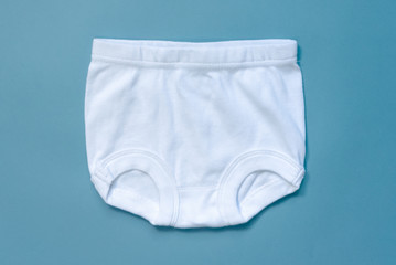 White baby panties on a blue background.