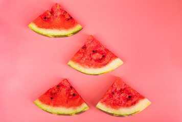 Watermelon slices on a pink background. Healthy food concept.