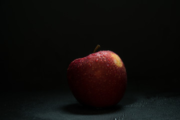 Red Apple with Waterdrops on black ground
