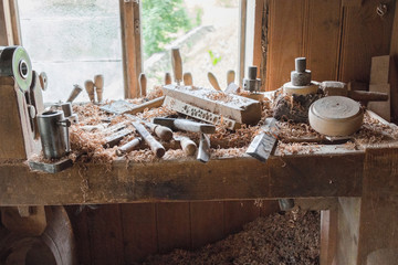 Vintage woodworking tools on a workbench, dust and shavings: carpentry, craftsmanship and handwork concept.