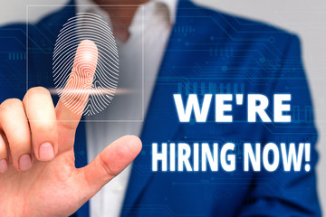 Conceptual hand writing showing We Re Hiring Now. Concept meaning recently employ someone or pay someone to do particular job Male wear formal work suit presenting presentation smart device