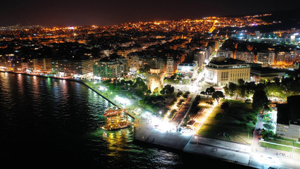 Fototapeta premium Aerial drone night shot of famous promenade area in new waterfront of Thessaloniki or Salonica featuring Alexander the Great statue, North Greece