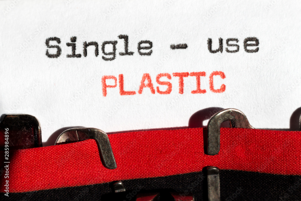 Fototapete single-use plastic typed on typewriter on black and red