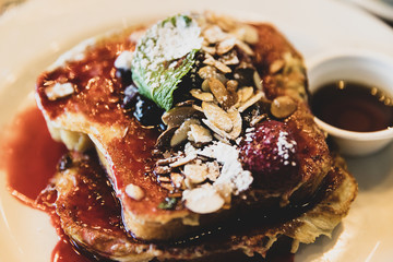 French Toast breakfast with fresh fruit, berries, syrup and nuts