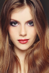Vintage style portrait of young beautiful girl with long hair and fancy make-up