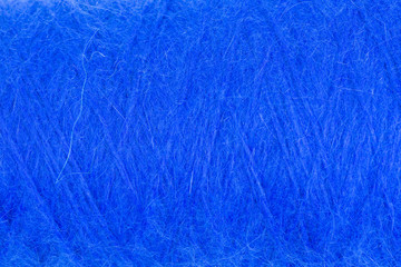 background of fluffy blue angora wool on a cone