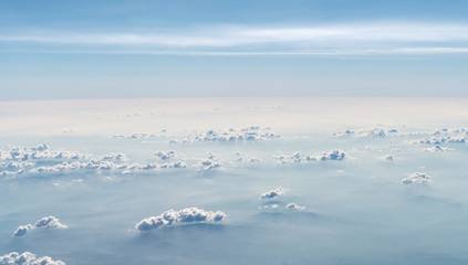 Beautiful Cloudscape. Aerial view of clouds and sky. Bird eye view from airplane window. Clouds panorama from airplane