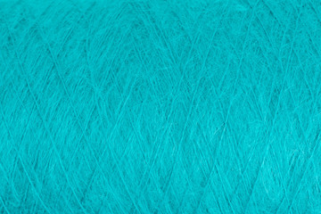 background of fluffy green mohair wool on a cone