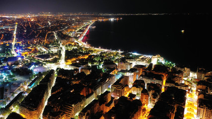 Aerial drone night shot of famous promenade area in new waterfront of Thessaloniki or Salonica featuring Alexander the Great statue, North Greece