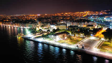 Aerial drone night shot of famous promenade area in new waterfront of Thessaloniki or Salonica featuring Alexander the Great statue, North Greece
