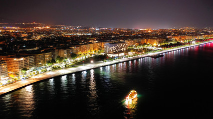 Fototapeta na wymiar Aerial drone night shot of famous promenade area in new waterfront of Thessaloniki or Salonica featuring Alexander the Great statue, North Greece