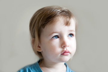 serious and sad three years old girl portrait